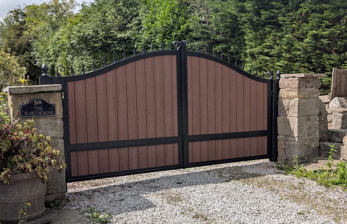 A smooth curved top gate with a golden oak colour composite infill
